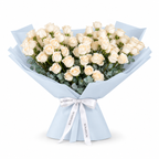 White roses and eucalyptus in blue wrapping with a Rosarium ribbon