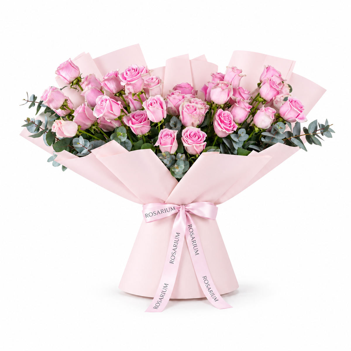 Wide bouquet of pink roses and eucalyptus in light pink wrapping with a Rosarium ribbon