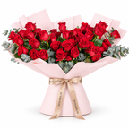 Wide bouquet of red roses and eucalyptus in light pink wrapping with a Rosarium ribbon
