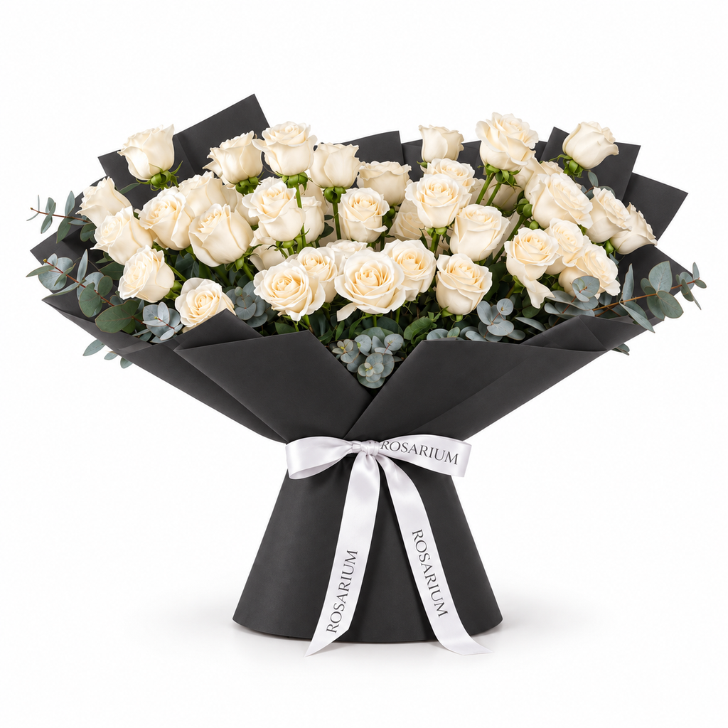 Wide bouquet of white roses and eucalyptus in black wrapping with a Rosarium ribbon