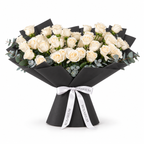 Wide bouquet of white roses and eucalyptus in black wrapping with a Rosarium ribbon
